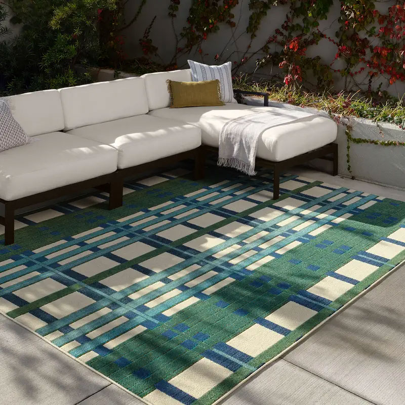 Green, blue, and tan outdoor rug